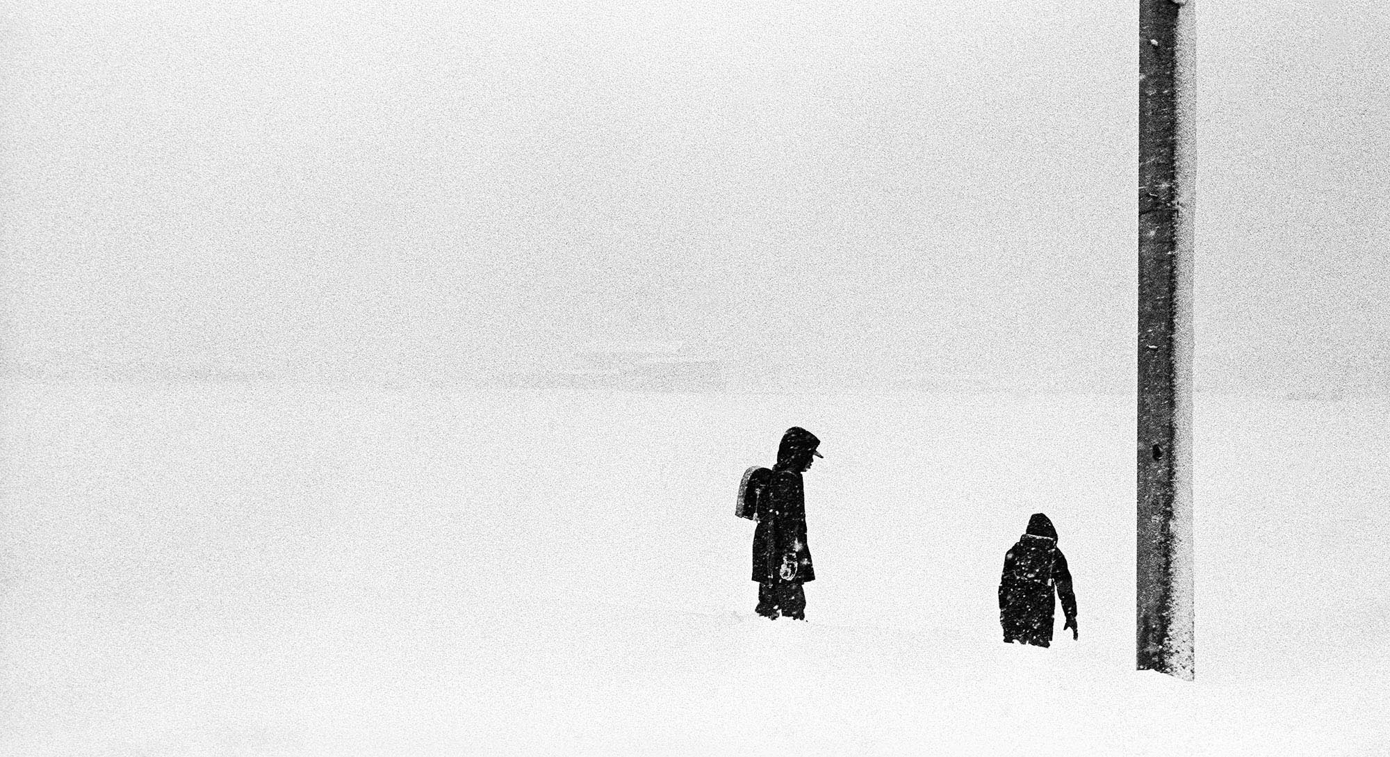 School children go home in the snow in Kurobe, Japan.